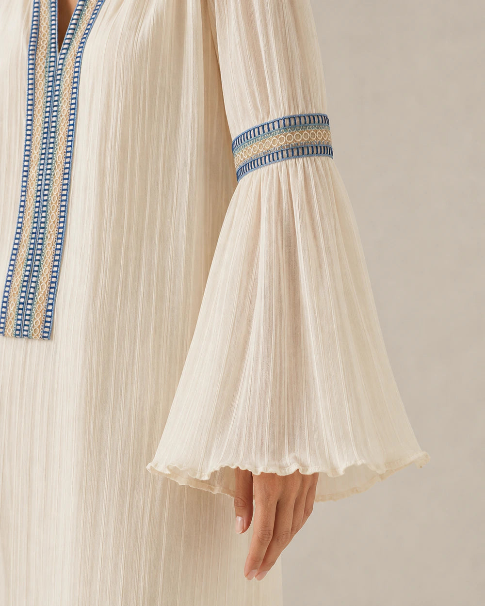 Ivory vintage blouse, embroidered bell-sleeve detail.