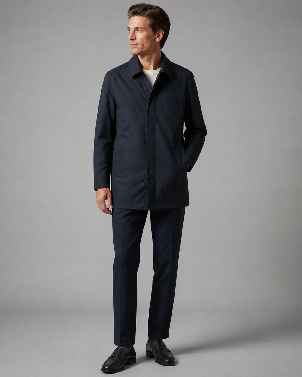 Dark blue mid-length coat for men, three-quarter view.