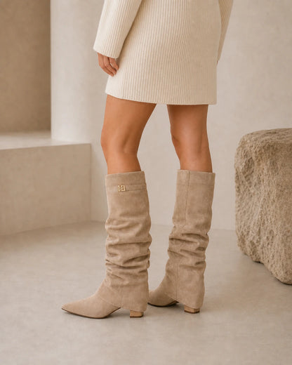 Women's light-brown ruched knee-high boots, rear three-quarter view.